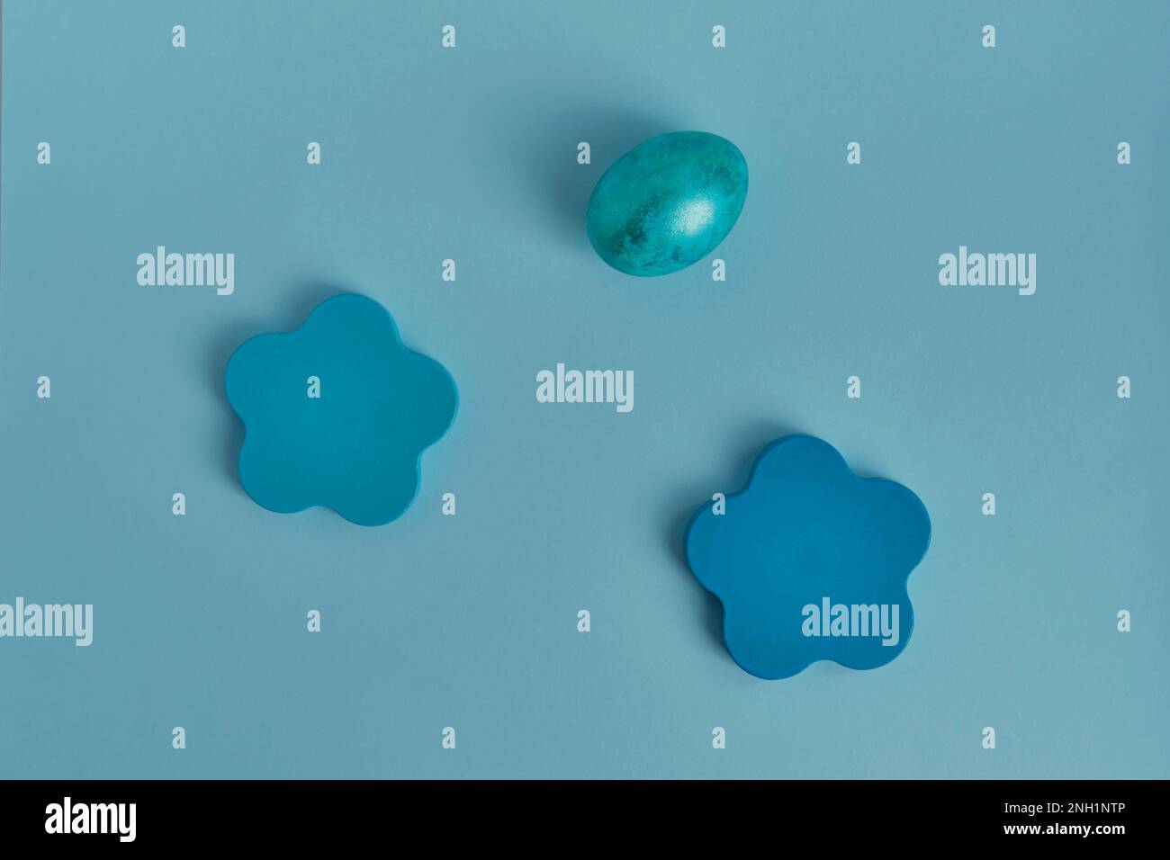 Painted blue egg, wooden round objects. Flat lay Stock Photo - Alamy