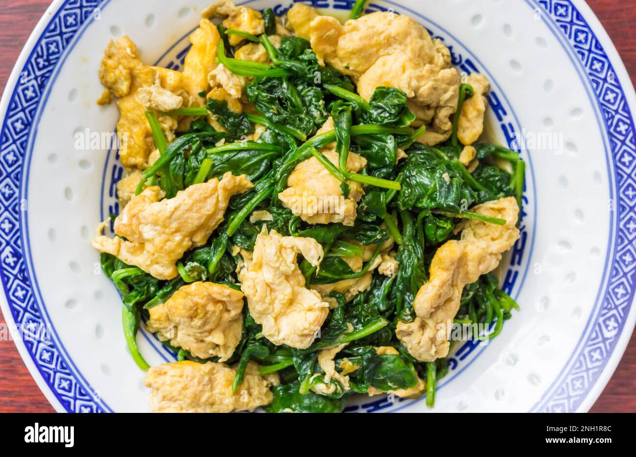 Traditional chinese stir fried vegetarian meal with egg and spinach Stock Photo