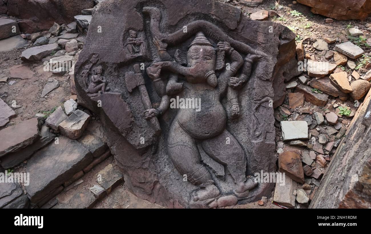 Carving of eight armed Standing tantric Lord Ganesh On Black Stone, Ajaygarh Fort, Panna, Madhya Pradesh, India. There are snakes in two of his hands. Stock Photo