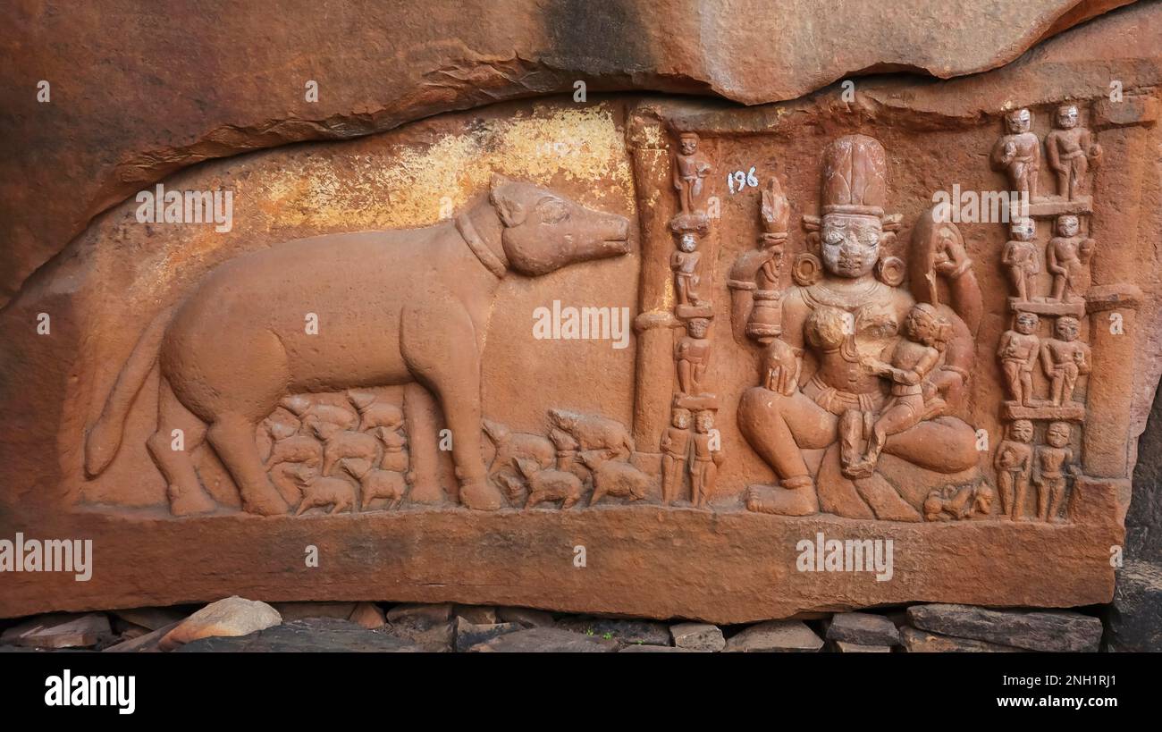 Carving of Cow feeding calves and Jain sculpture on the wall of Ajaygarh Fort, Panna, Madhya Pradesh, India. Stock Photo