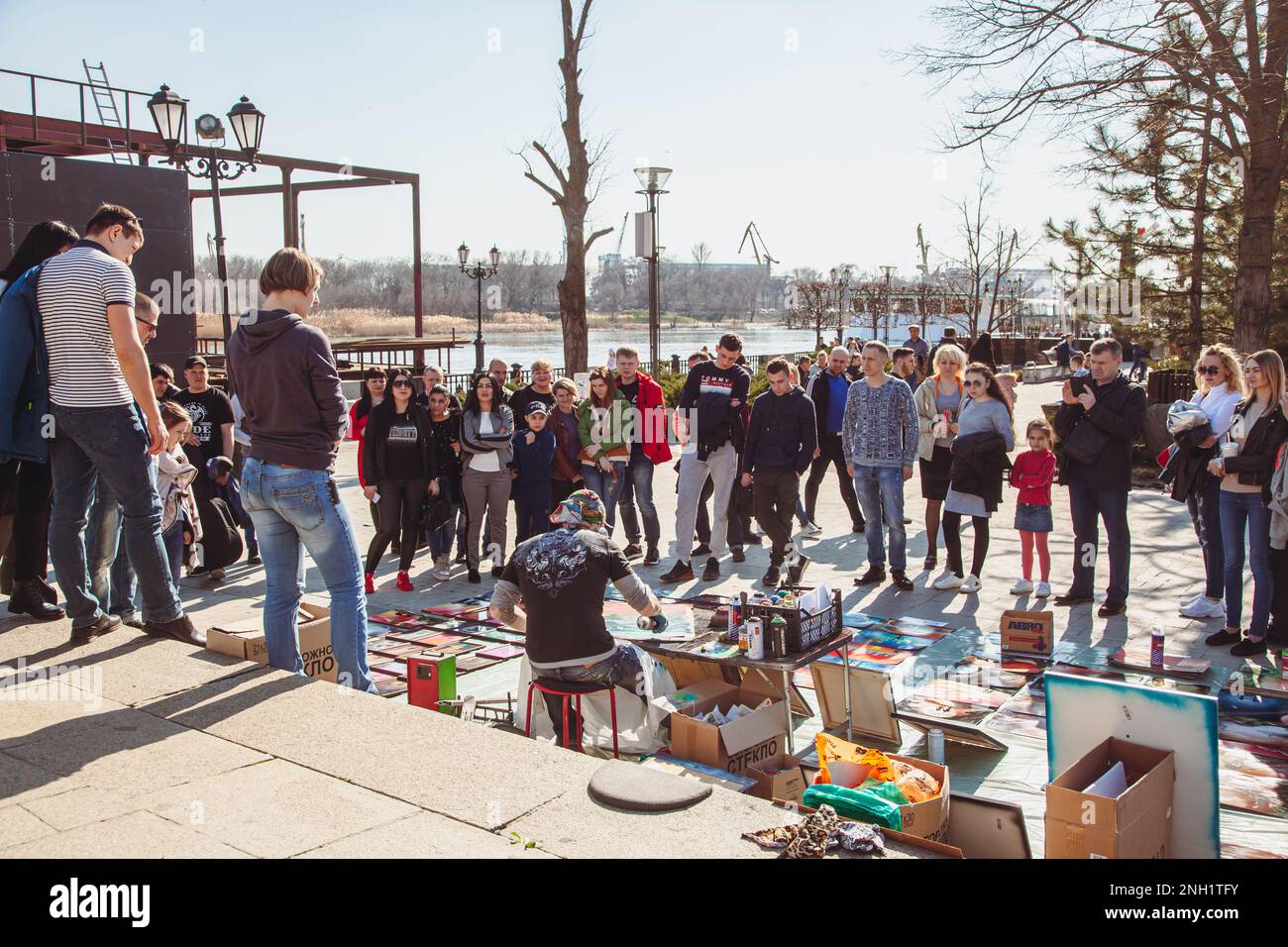 Artist on embankment, surrounded by crowd of people, draws in technique of airbrushing with help of spray cans with paint Russia, Rostov-on-Don - Marc Stock Photo