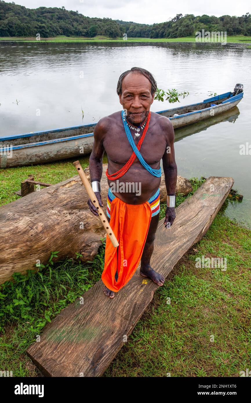 The shaman or village medicine man of an indigenous Embera village in traditional dress with his flute and his body painted with the juice of the jagu Stock Photo