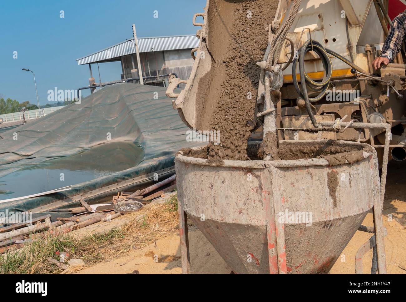 Load concrete from truck to bucket in construction site Stock Photo Alamy