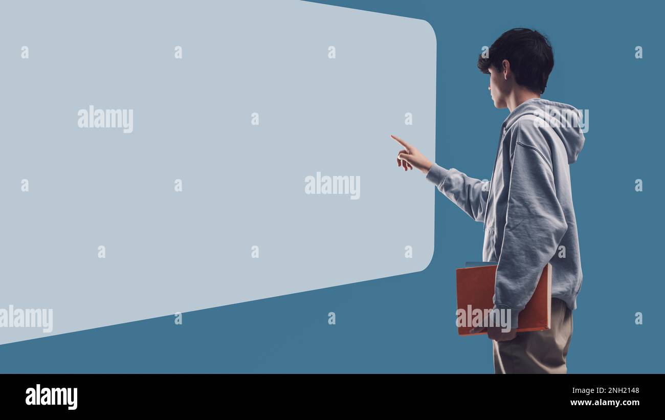 Student Using Touch Screen Adolescent student interacting with a touch screen whiteboard, online ...