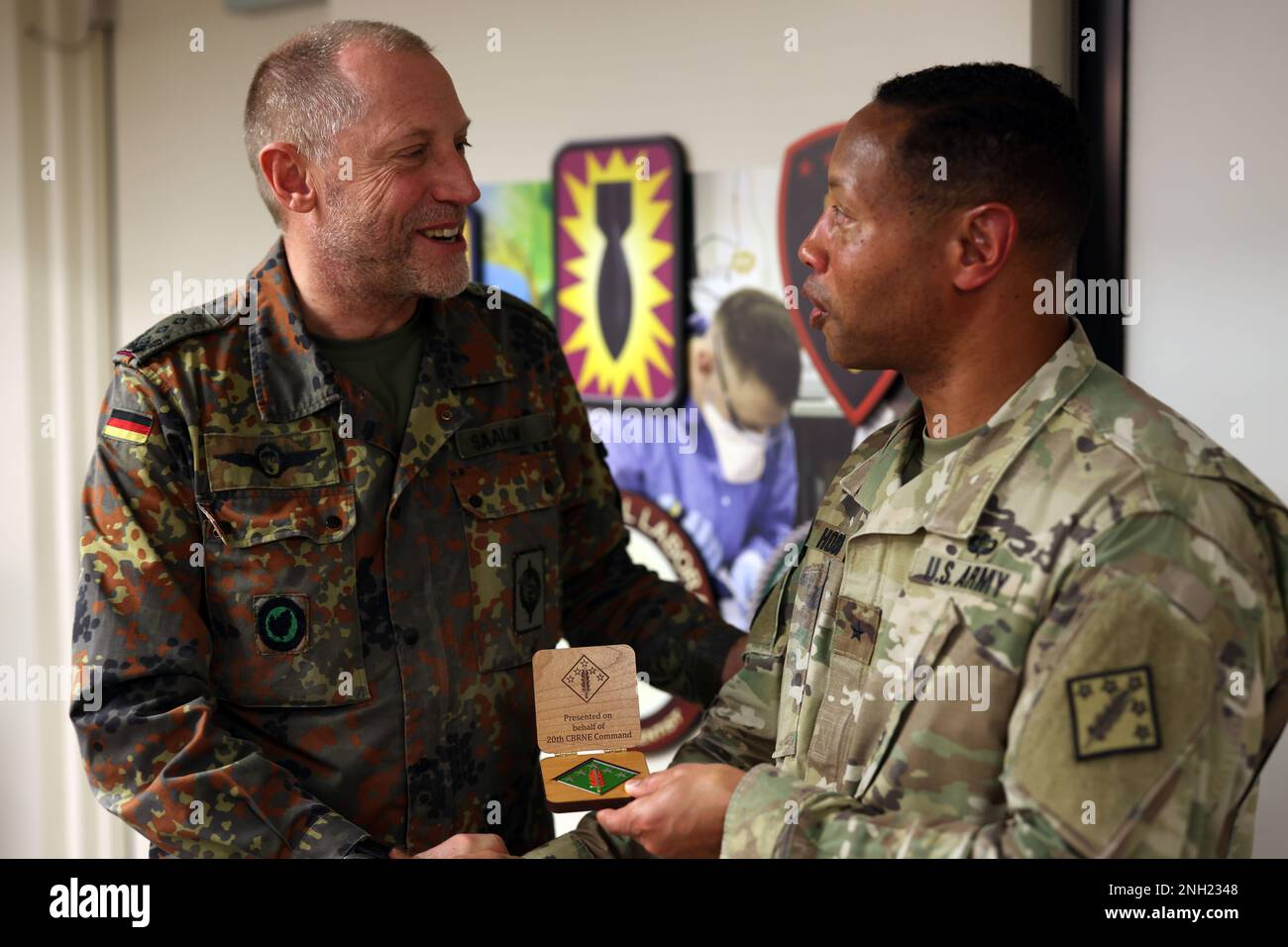 Brig. Gen. Daryl O. Hood (right), the commanding general of the 20th Chemical, Biological, Radiological, Nuclear, Explosives (CBRNE) Command, shakes hands with Col. Stephan Saalow, the commander of the German CBRN Defense Command, Dec. 7.  The two commanders exchanged command briefs and discussed training exercises that support building partnership capacity opportunities. U.S. Army photo by Marshall R. Mason. Stock Photo