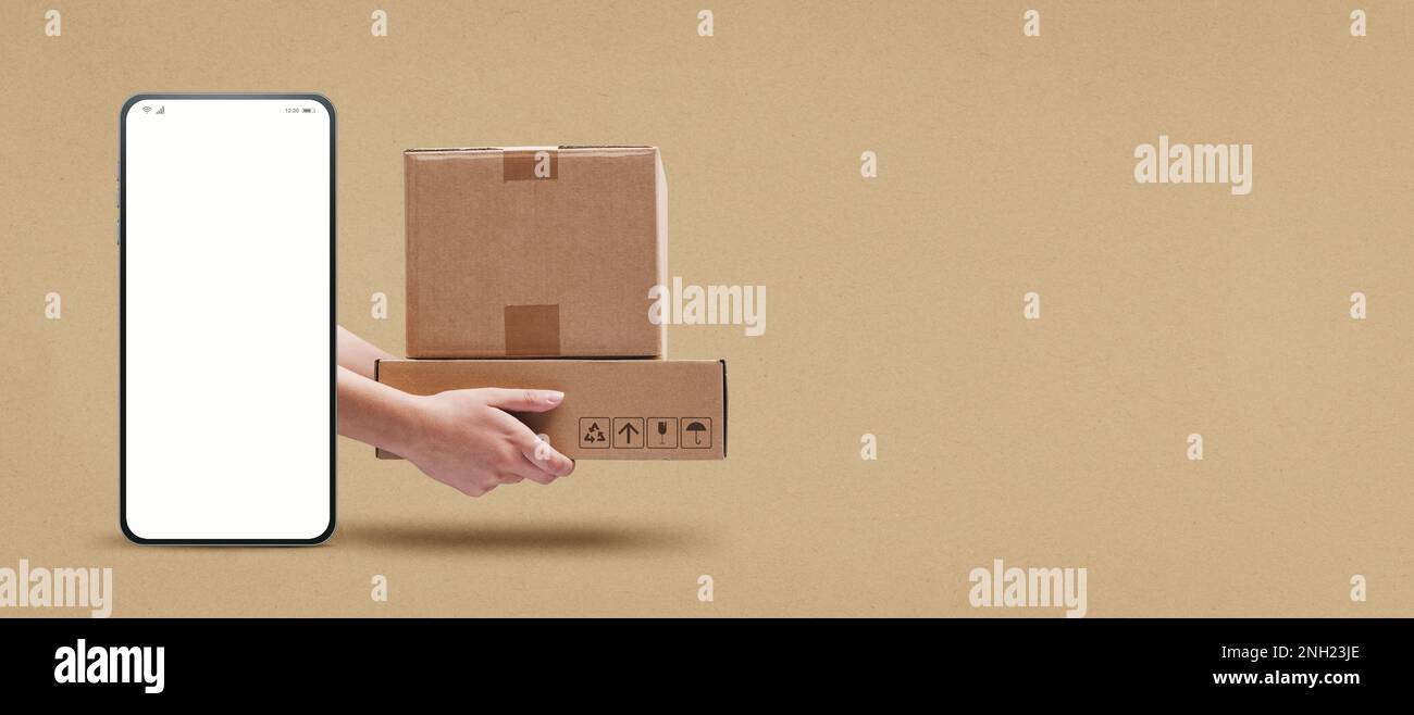 Hands holding cardboard boxes and smartphone with blank screen, express