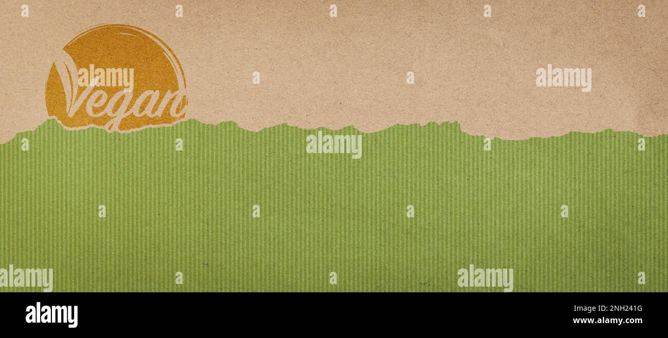 Vegan symbol on ripped recycled paper, vegan products and