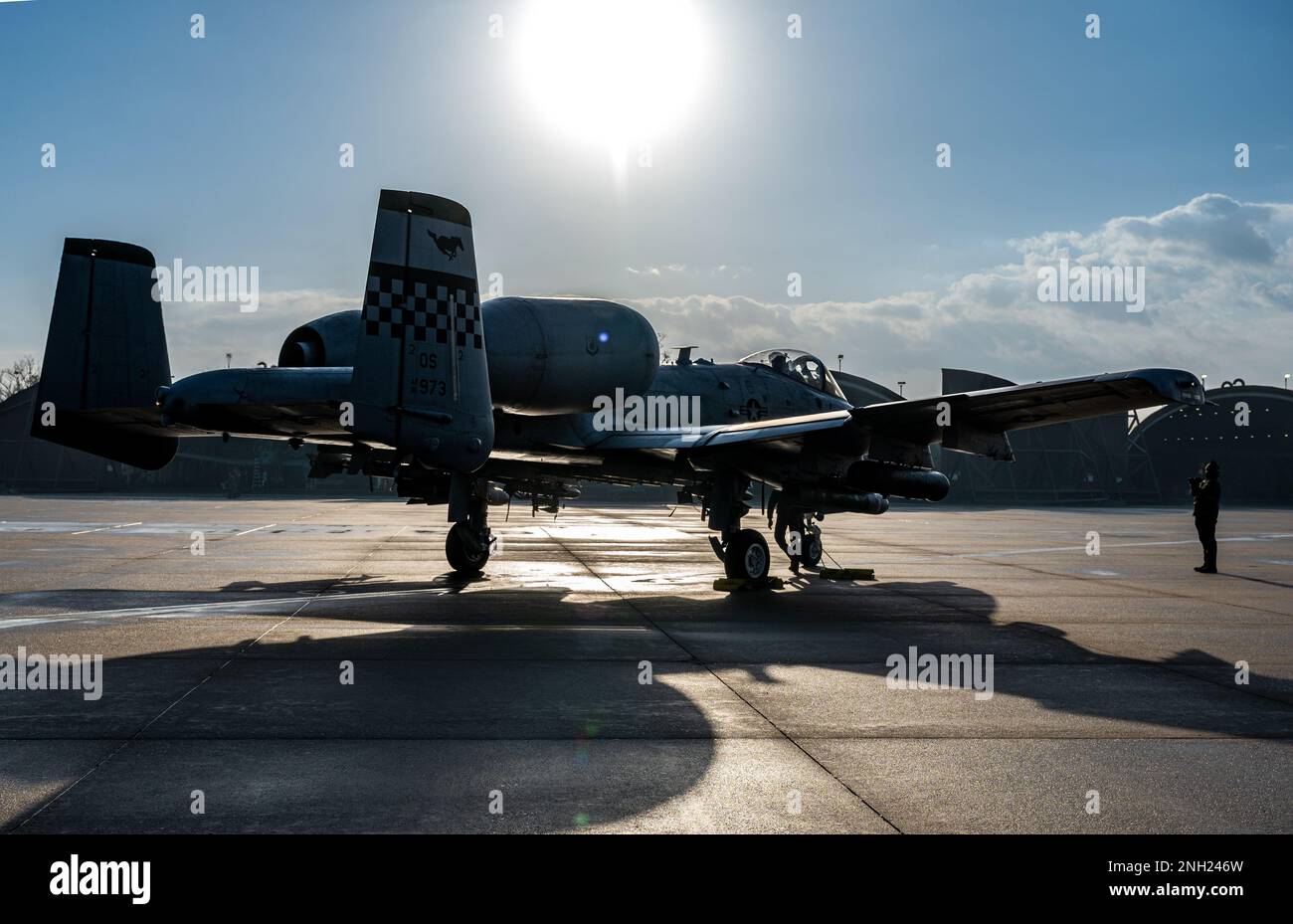 A U.S Air Force Airmen assigned to the 25th Fighter Generation Squadron signals an A-10C Thunderbolt II on the flightline at Osan Air Base, Republic of Korea, Dec. 7, 2022. Prior to launches, crew chiefs and pilots communicate and perform functional procedures to ensure aircraft are mission capable for flight. Stock Photo