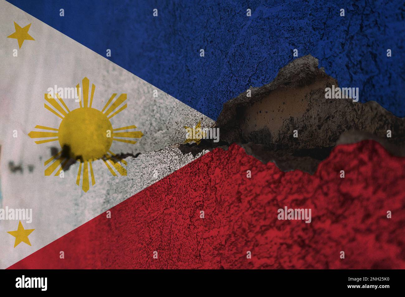 Philippines flag on cracked wall. Earthquake or drought concept Stock