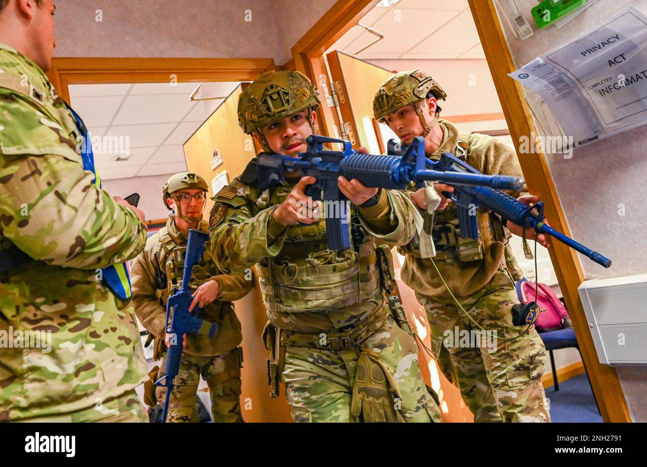 Airmen assigned to the 100th Security Forces Squadron conduct a search for a simulated active shooter during an exercise at Royal Air Force Mildenhall, England, Dec. 7, 2022. Readiness exercises help prepare Airmen to execute their assigned duties in a real-world incident. Stock Photo