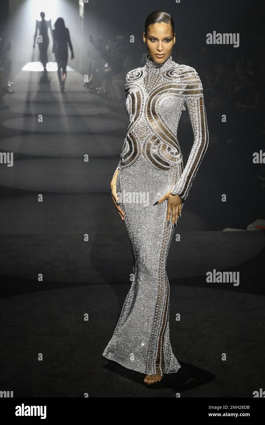 Cindy Bruna, model, walks in floor length metallic gown. Models on the