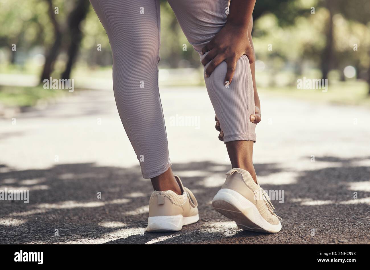 This leg injury keeps acting up. a woman massaging an injury in her leg ...
