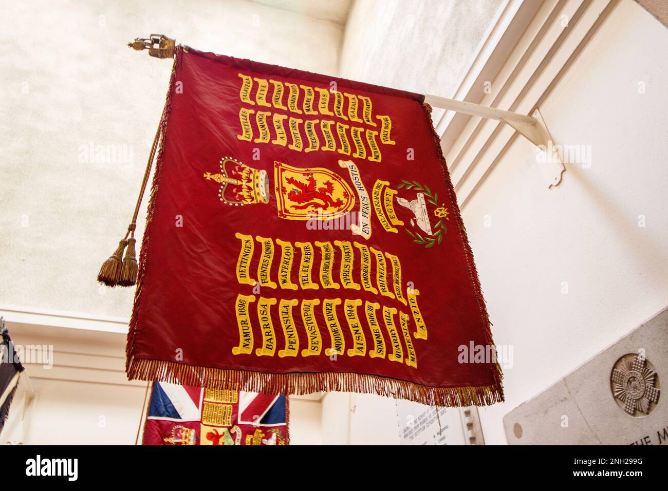 St Columba's Church is one of the two London congregations of the Church of Scotland. Pictured, a regimental flag of the London Scottish regiment bearing campaigns. The flag is situated in a small chapel in the church Stock Photo