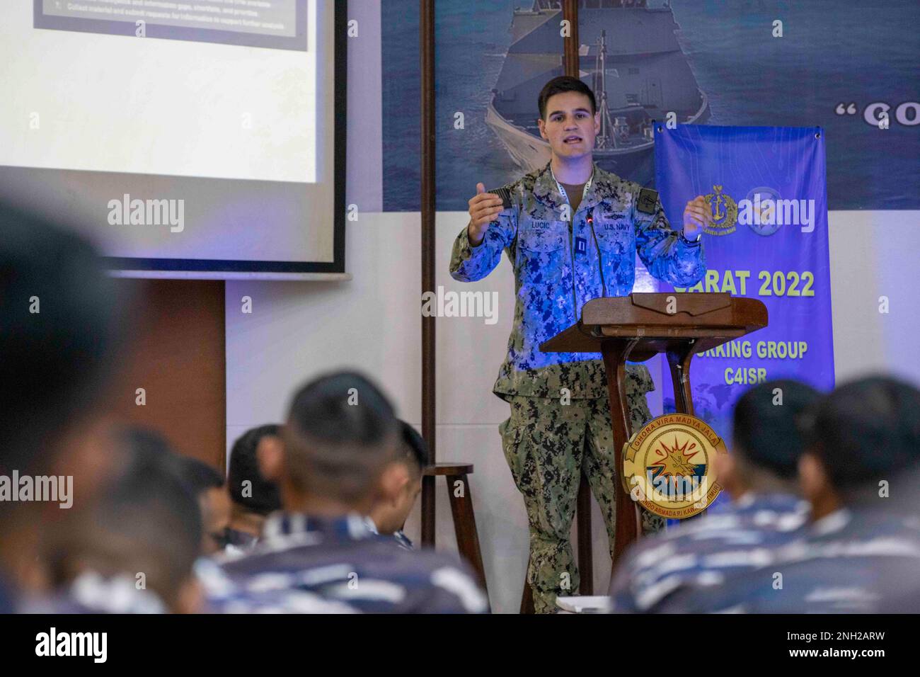 Lt. Thomas Lucic, assigned to Destroyer Squadron (DESRON) 7, conducts a subject matter expert exchange on maritime domain awareness with Indonesian Navy (TNI-AL) during Cooperation Afloat Readiness and Training (CARAT) Indonesia 2022 in Pangkoarmada II Fleet Navy Base, Indonesia, Dec. 7. CARAT Indonesia is a bilateral exercise between Indonesia and the United States designed to promote regional security cooperation, maintain and strengthen maritime partnerships, and enhance maritime interoperability. In its 28th year, the CARAT series is comprised of multinational exercises, designed to enhanc Stock Photo