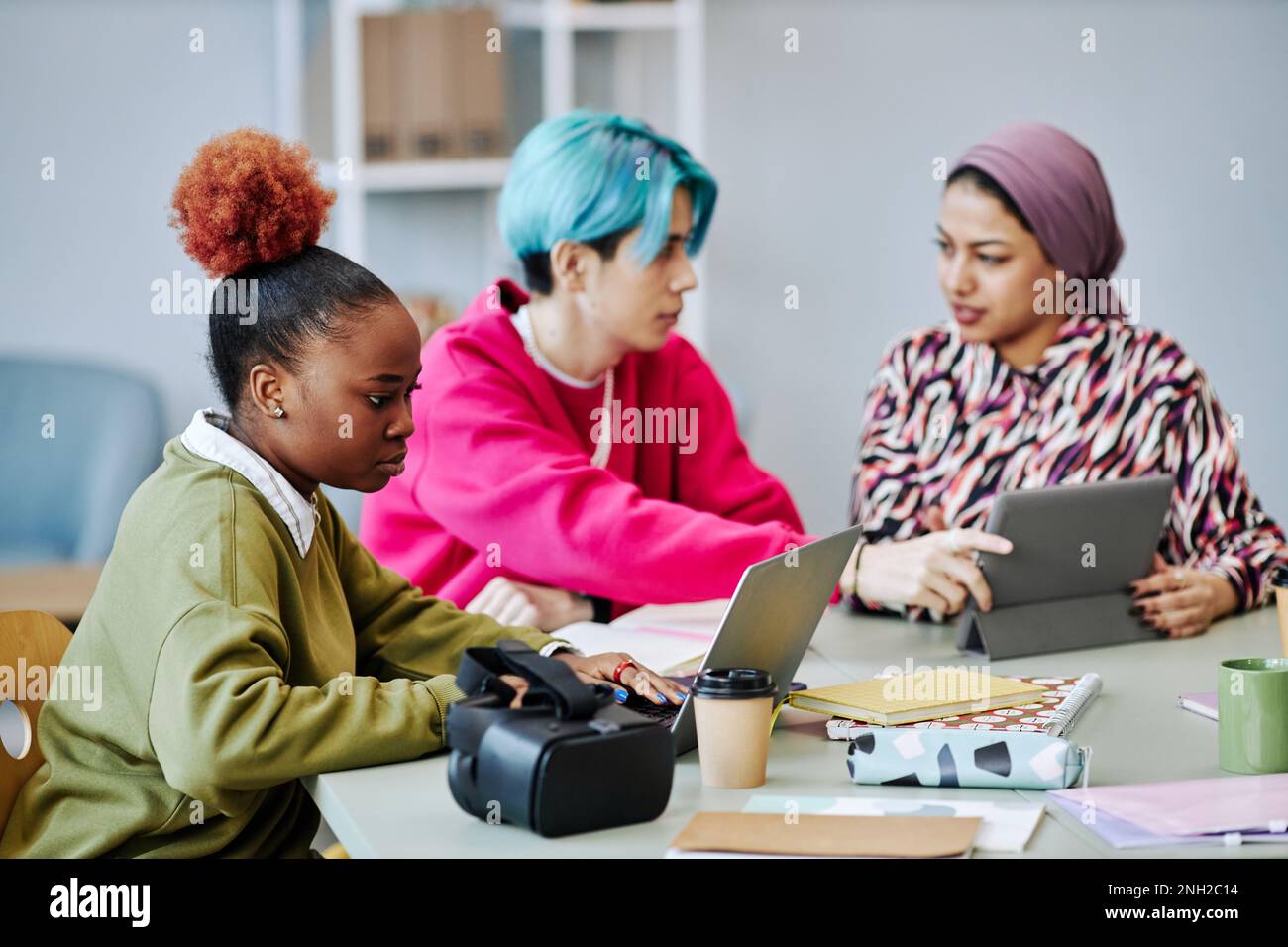 Side view portrait of black young woman using laptop during meeting in ...