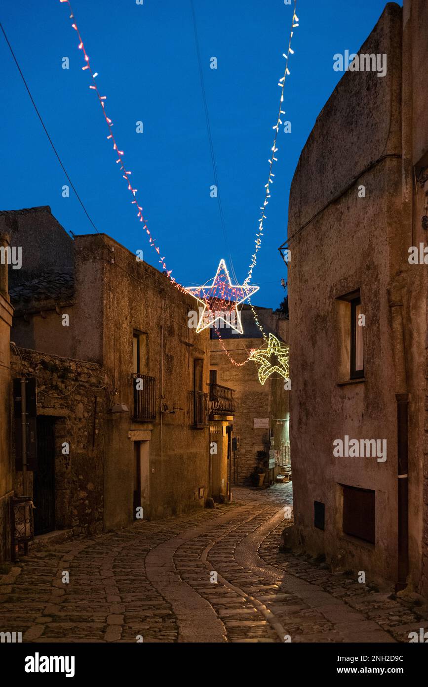 A characteristic alleyway with Christmas lights in the medieval village of Erice, Sicily Stock Photo