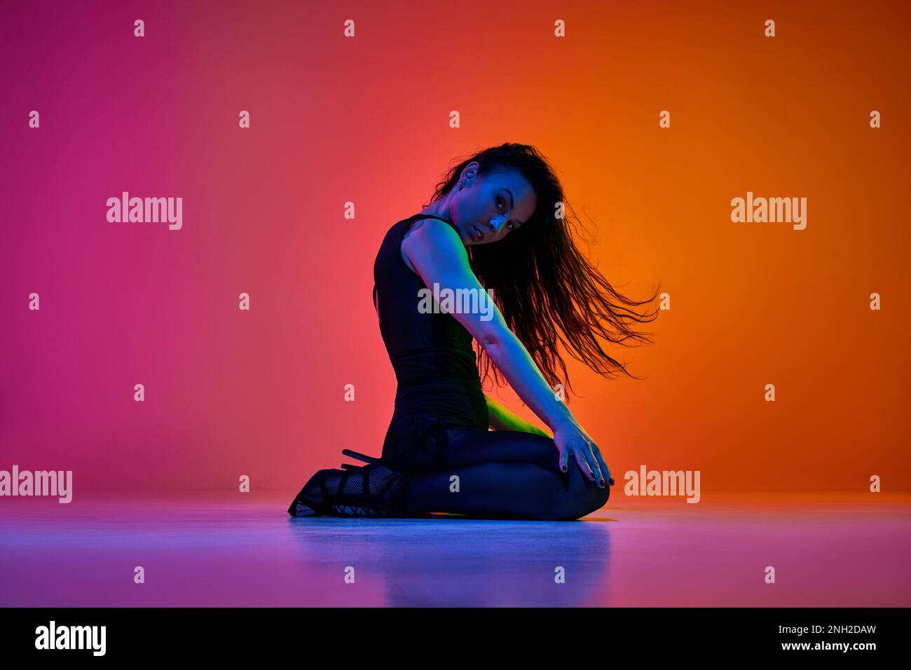 Expressive dance. Young woman, stiletto dancer performing over gradient