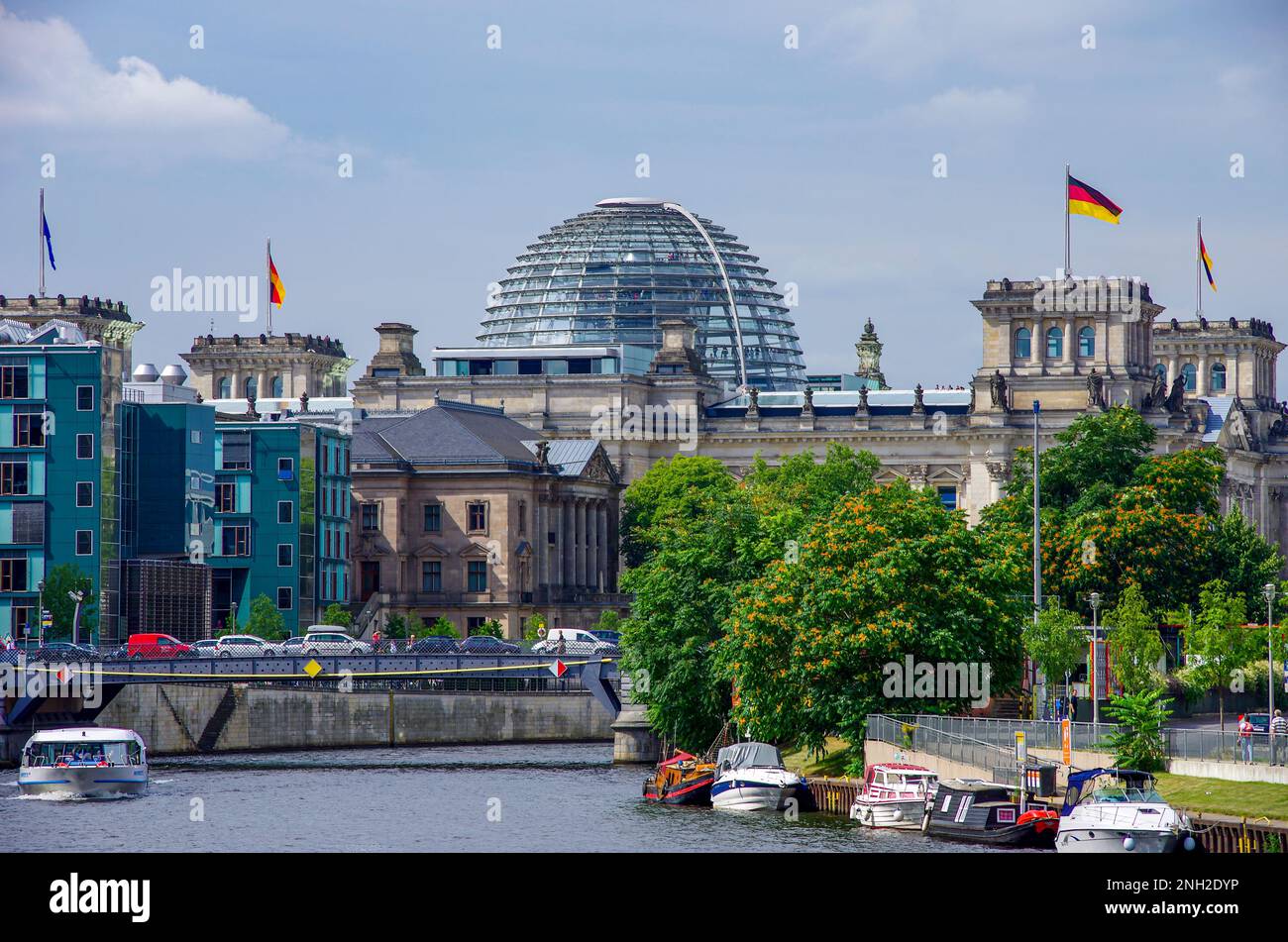 View along the Spree river with excursion boats towards the German Bundestag in the former Reichstag building, government district of Berlin, Germany. Stock Photo