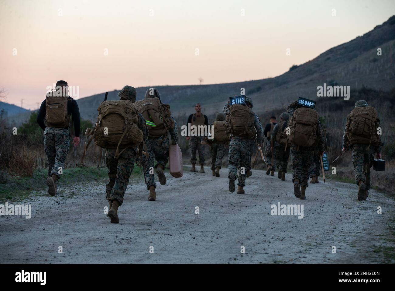 U.S. Marines with I Marine Expeditionary Force Information Group, run during a martial arts instructor course physical training session at Marine Corps Base Camp Pendleton, California, Dec. 8, 2022. MAI courses certify Marines to instruct and monitor Marine Corps Martial Arts Program training and advance Marines in the program, distinguishing their levels of experience with different colored belts. Stock Photo