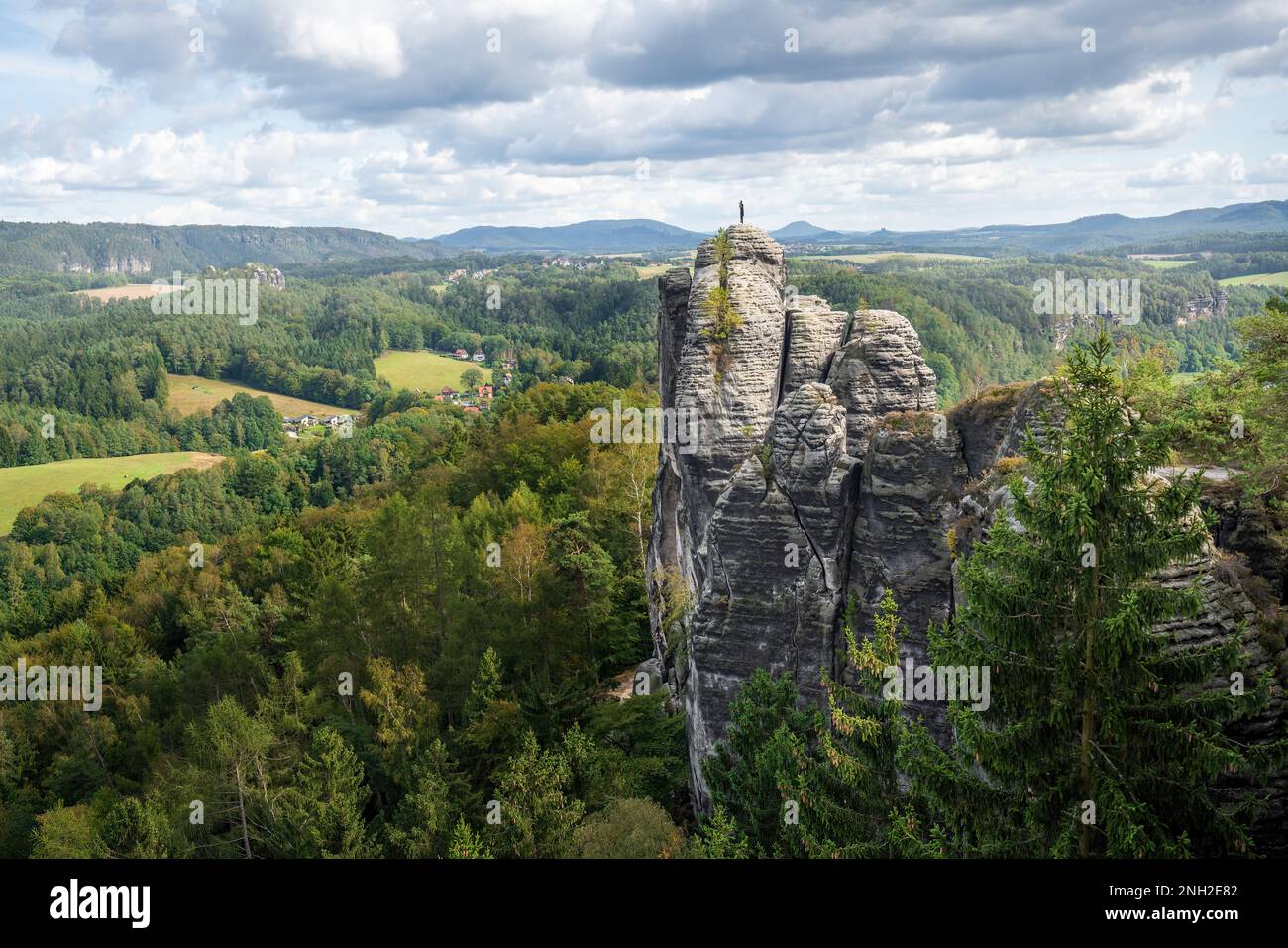 Monch (Monk) rock pinnacle with weather vane part of  Elbe sandstone mountains near Bastei Bridge (Basteibrucke) - Saxony, Germany Stock Photo
