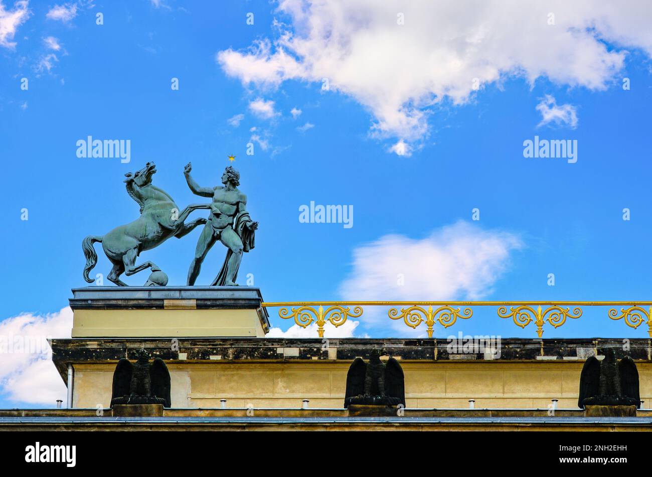 Horse Tamer, equestrian statue of a man taming a horse, by Christian Friedrich Tieck on the roof of the Old Museum (Altes Museum) in Berlin, Germany. Stock Photo