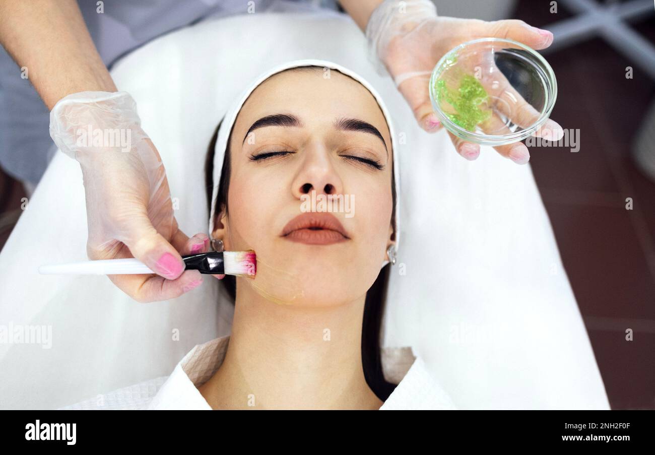 Beautiful caucasian girl is doing a cosmetic procedure. The beauty