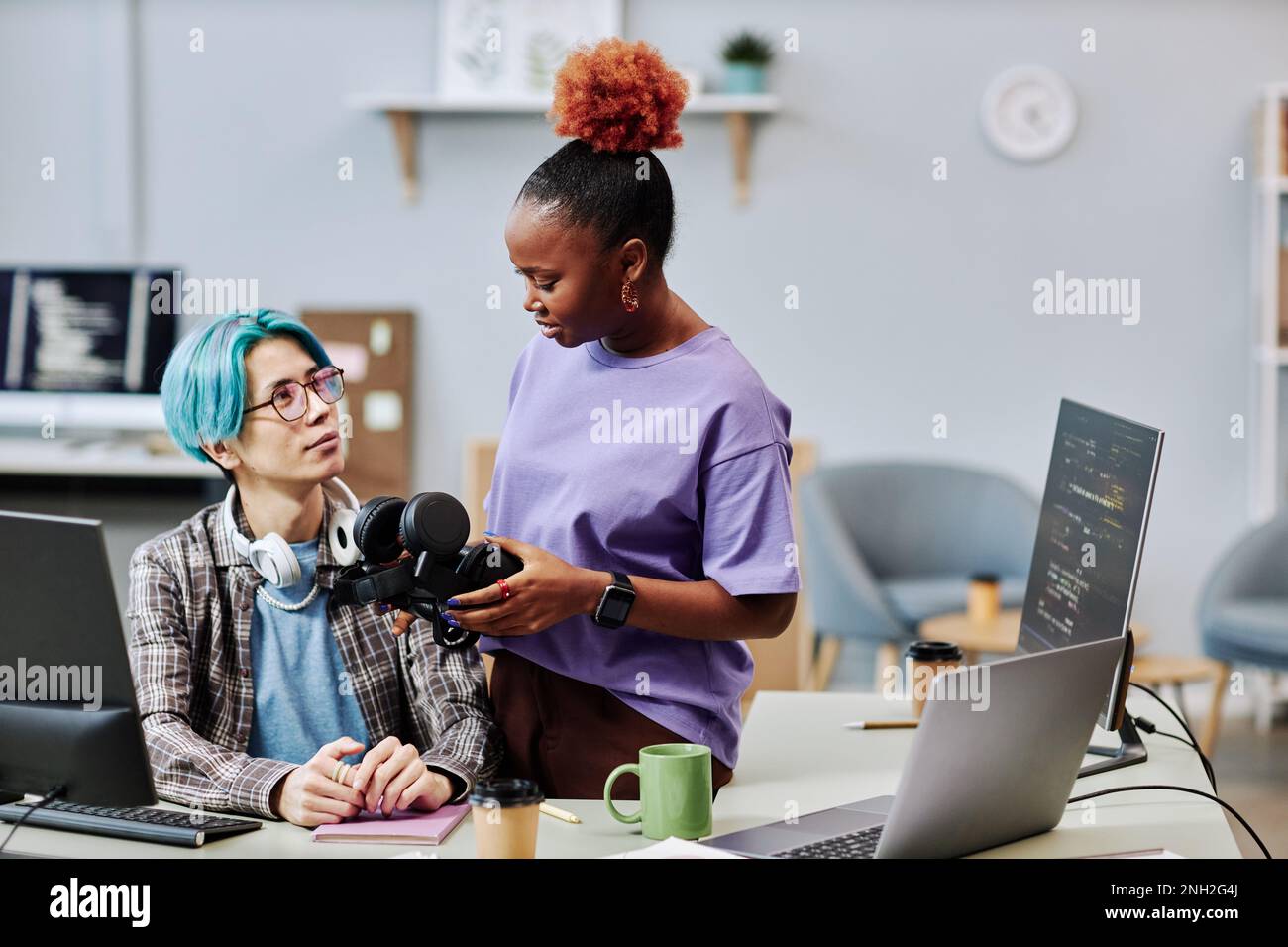Portrait of young software developers working on VR programming in office Stock Photo