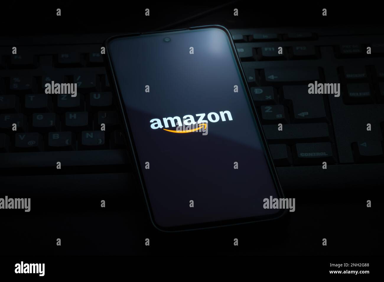 Ljubljana, Slovenia - 21 January 2023: Amazon logo on smartphone screen laying on computer keyboard Stock Photo