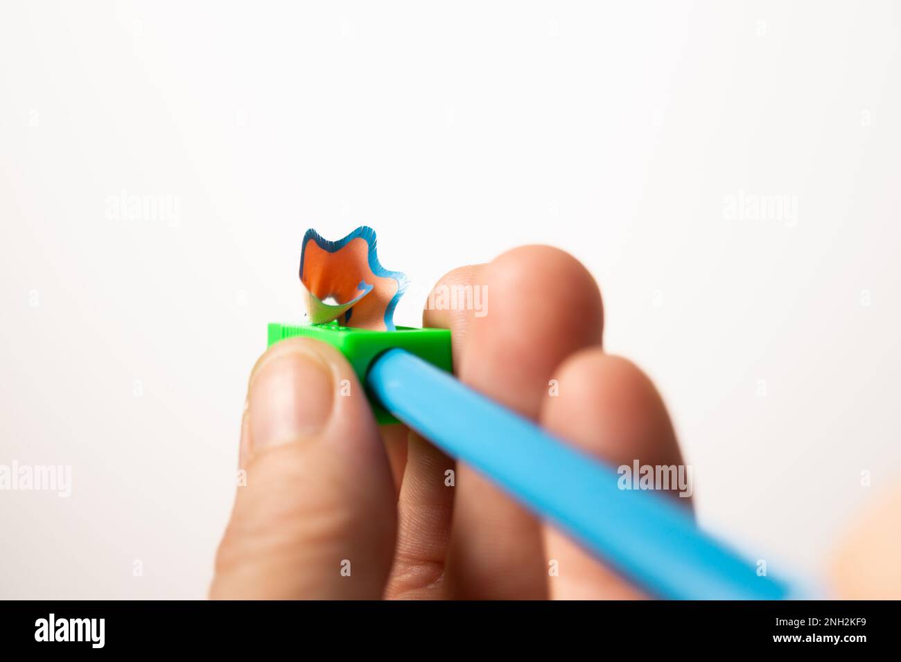 woman's hand with pencil sharpener in white background Stock Photo