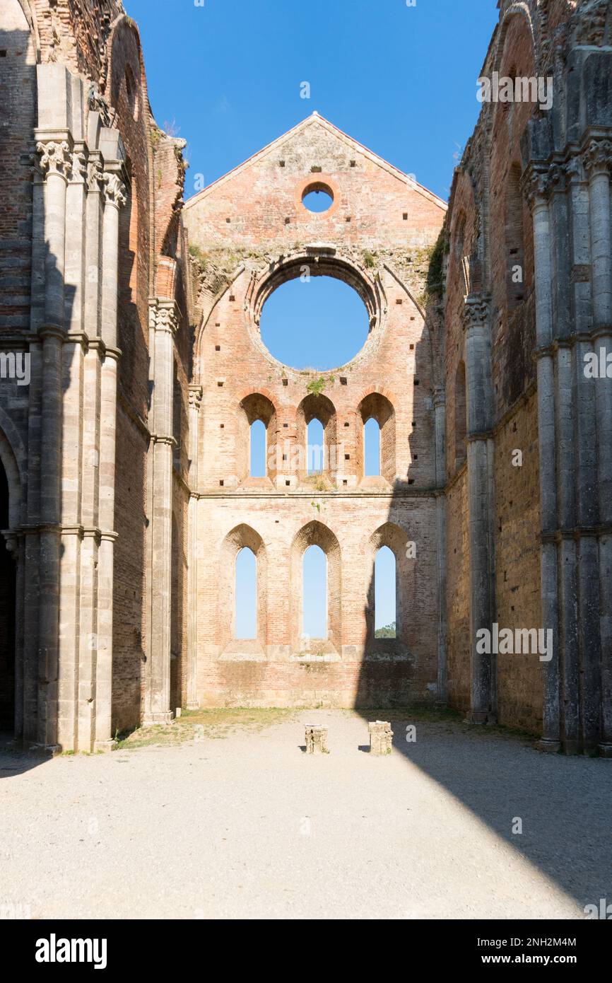 San Galgano ,Italy-august 8,2020:view of the interior of the abbey and former monastery of San Galgano famous for being roofless during a sunny day in Stock Photo