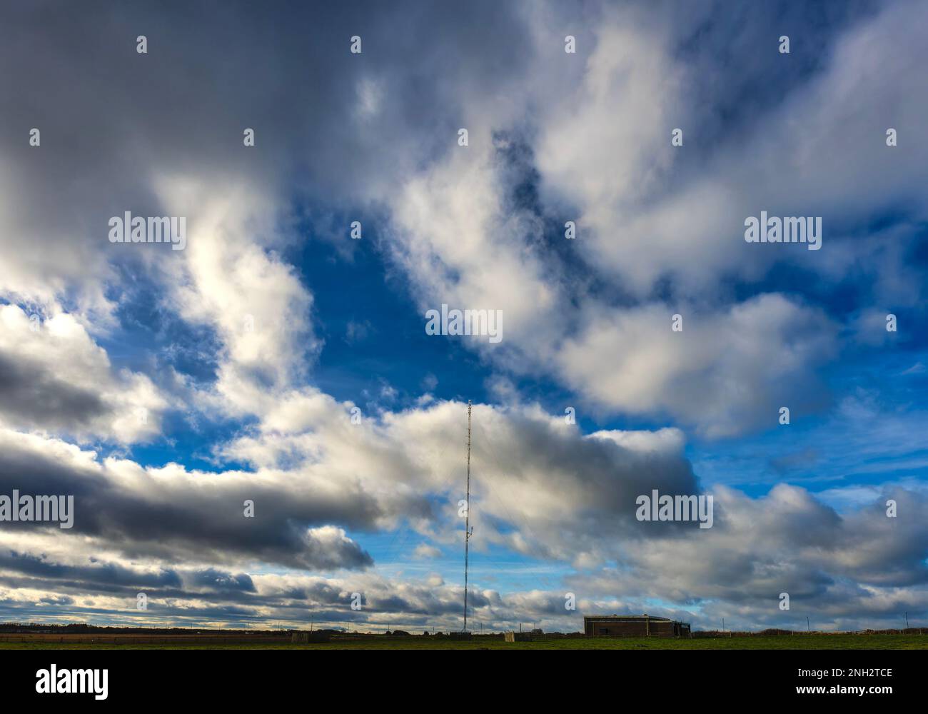 Large radio trandmitter tower in a cloud filled sky Stock Photo