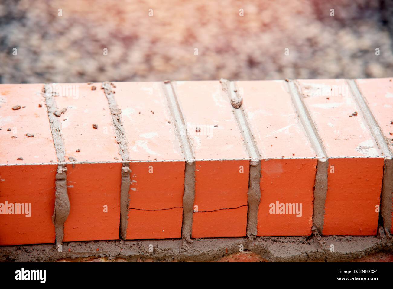 Close up of a brick wall and jointer trowel used by the worker to apply