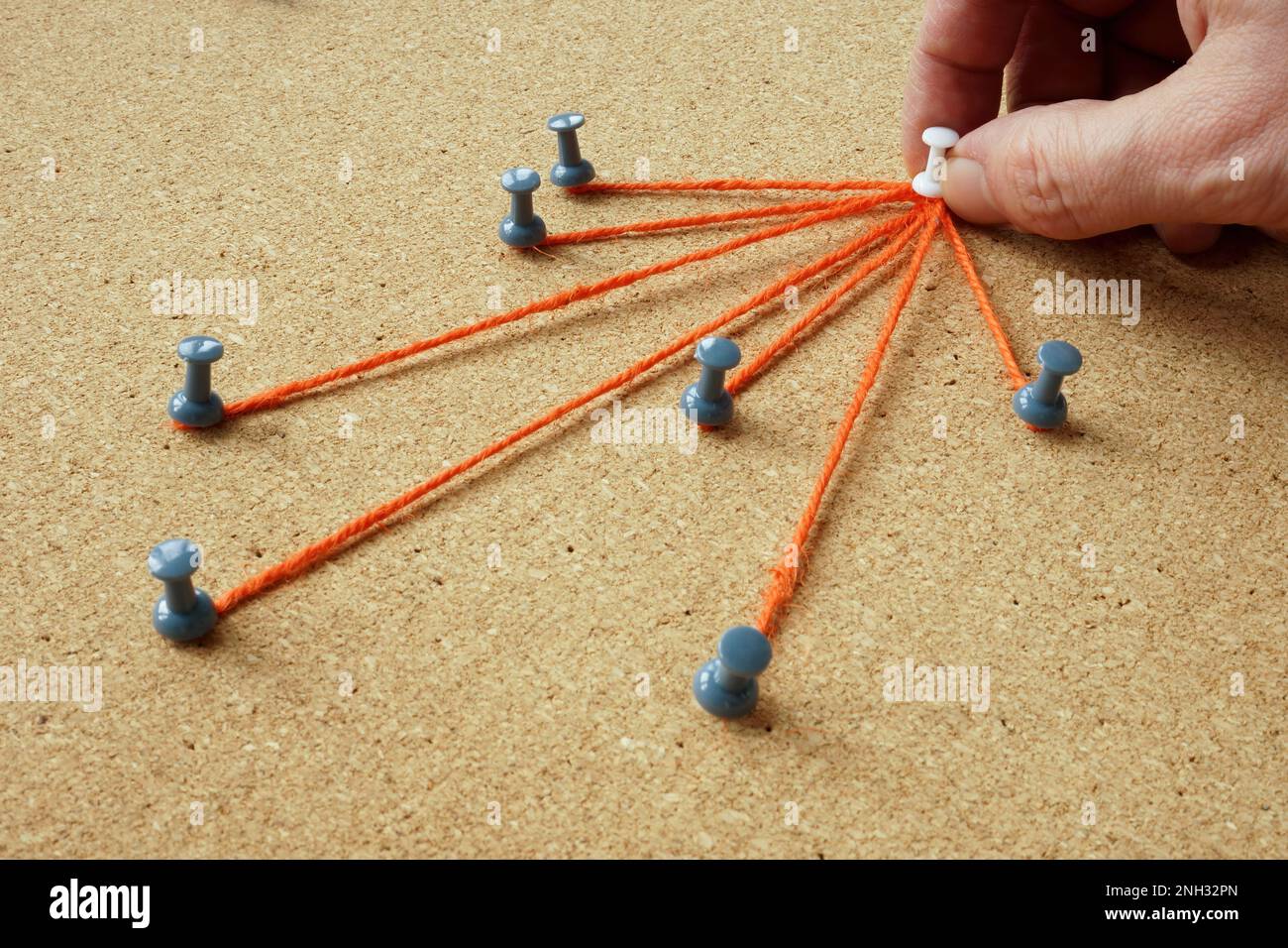 The pins are connected by a thread and the hand holds the main one