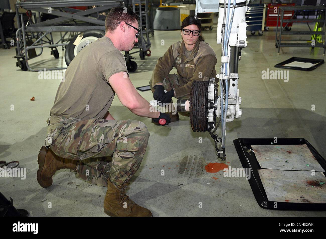 Master Sgt. Keith Hardy, phase work leader, and Staff Sgt. Julia Dunham, aircraft mechanic, both from the 127th Maintenance Squadron, Selfridge Air National Guard Base, Michigan, repack the brake and wheel assembly strut on an A-10 Thunderbolt II during a Phase 1 inspection on Dec. 9, 2022. Airmen of the 127th Maintenance Squadron phase crew are tasked to perform detailed inspections to make sure this complex jet remains air ready. Stock Photo