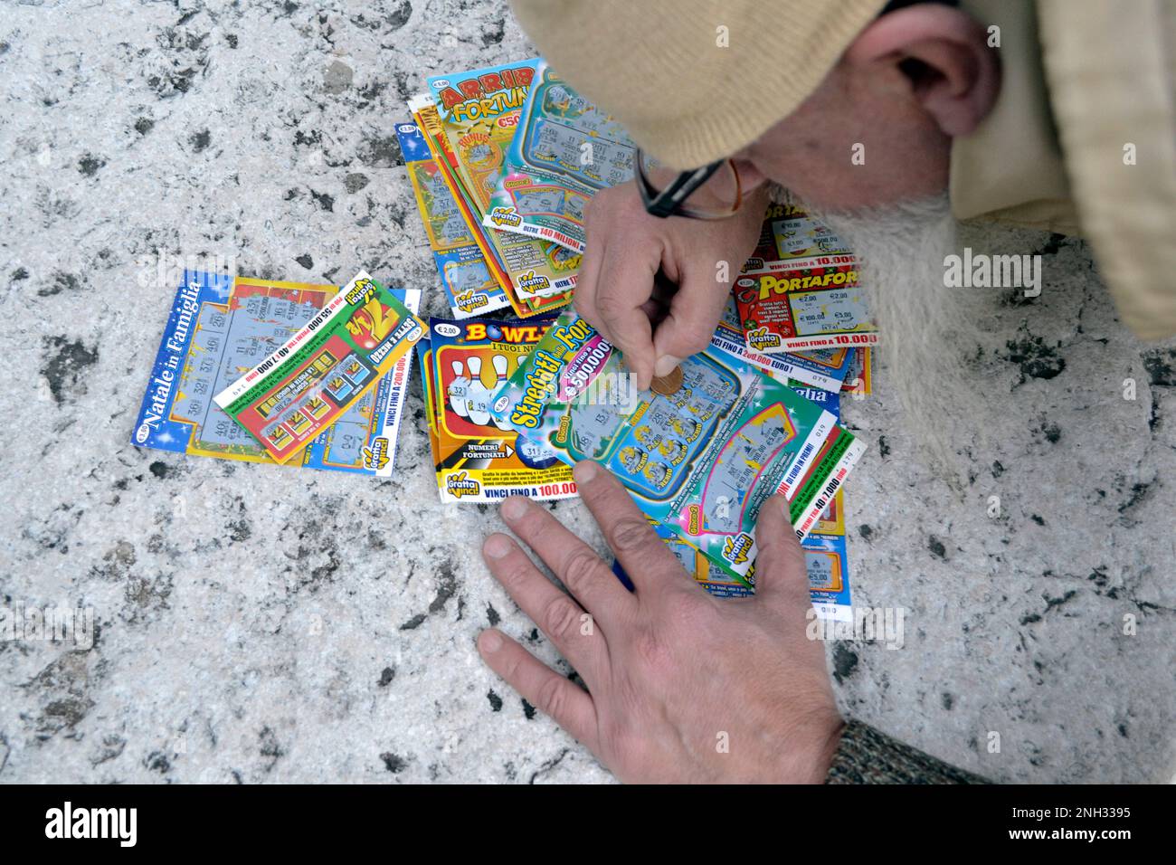 A man scratching a lottery scratch card Gambling addiction concept