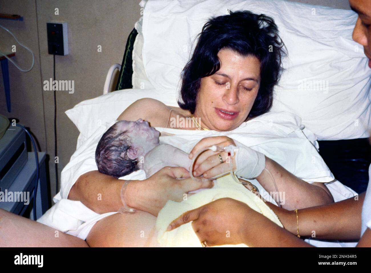 New Born Baby & Mother Baby Covered In Vernix Caseosa Natural Occurring Biofilm Surrey England Stock Photo