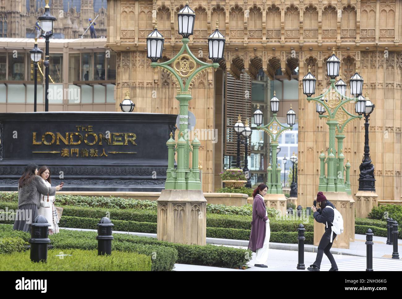 Tourists pose for pictures outside the Londoner, a casino resort in ...