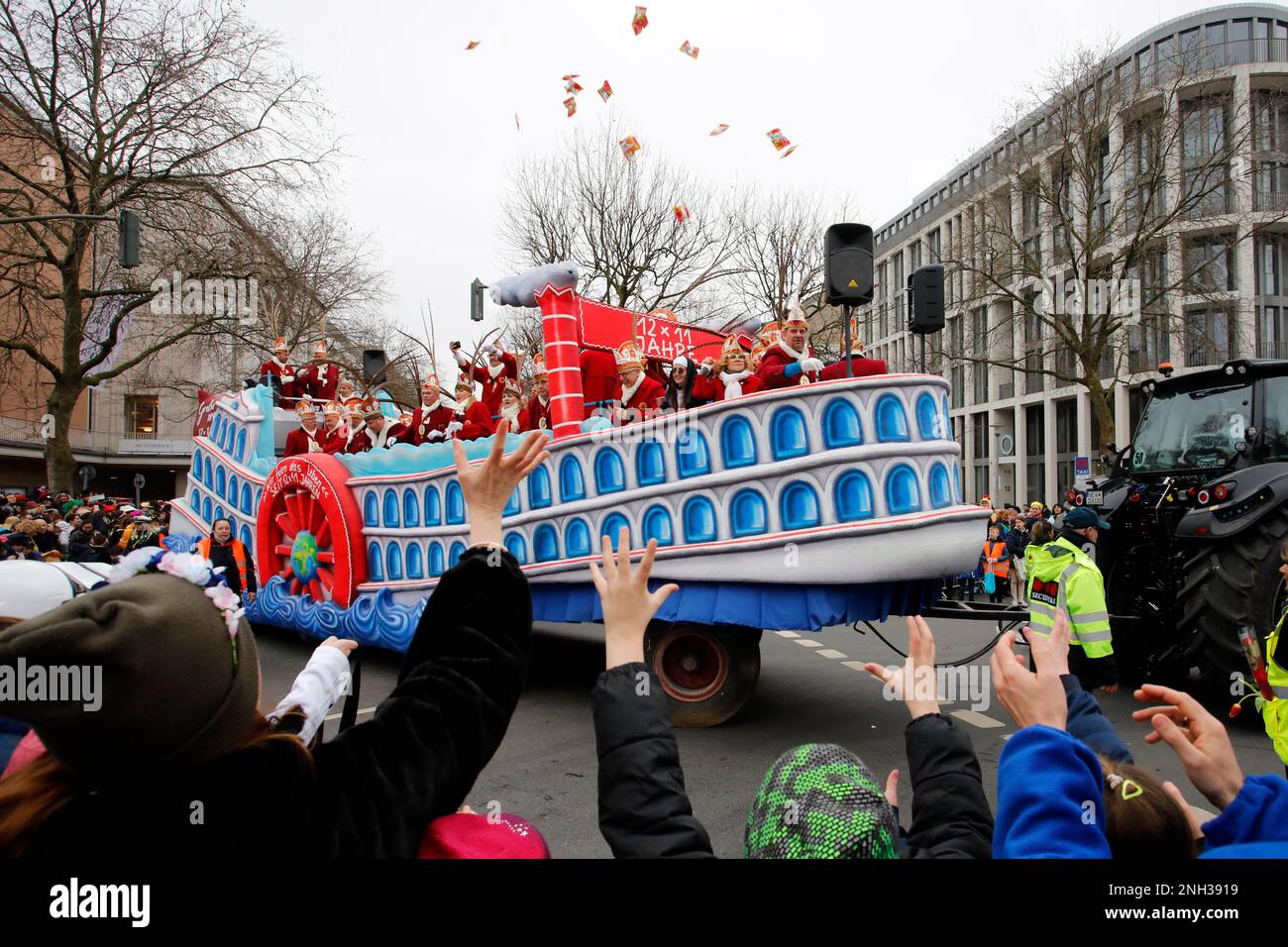 Crowds of many masked revelers cheer the Rose Monday parade in Düsseldorf Stock Photo