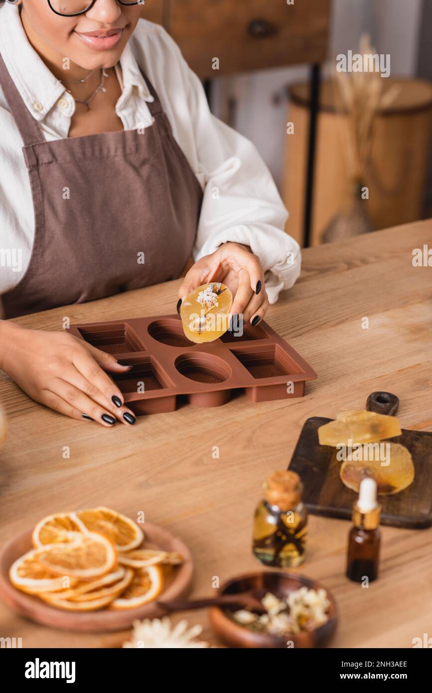 https://c8.alamy.com/comp/2NH3AEE/partial-view-of-african-american-craftswoman-with-handmade-soap-near-silicone-mold-and-natural-ingredients-on-wooden-tablestock-image-2NH3AEE.jpg