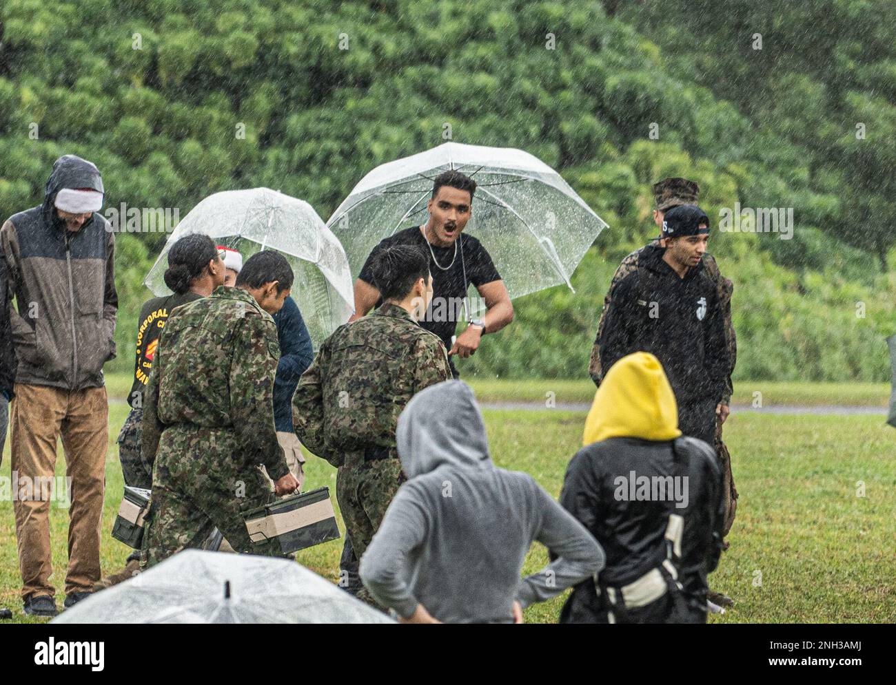 Personnel with the Japan Ground Self-Defense Force’s 15th Logistics Support Unit carry ammo cans during a bilateral field meet on Camp Kinser, Okinawa, Japan, Dec. 9, 2022. CLR-37 conducted a bilateral field meet to celebrate the holiday season and boost morale with their JGSDF counterparts. Stock Photo