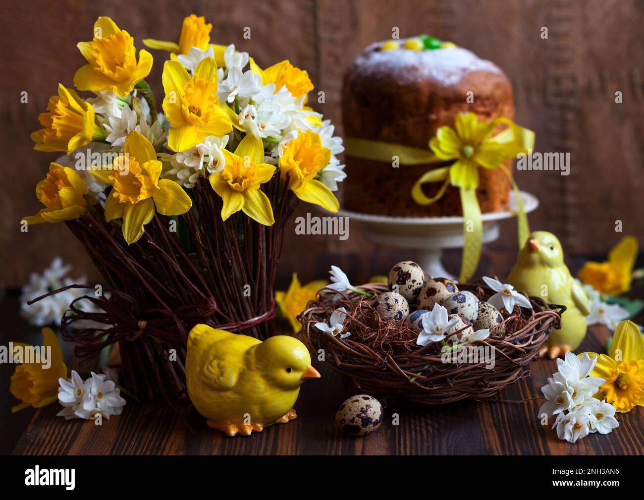 Easter table decoration with fresh daffodils,chick and eggs Stock Photo
