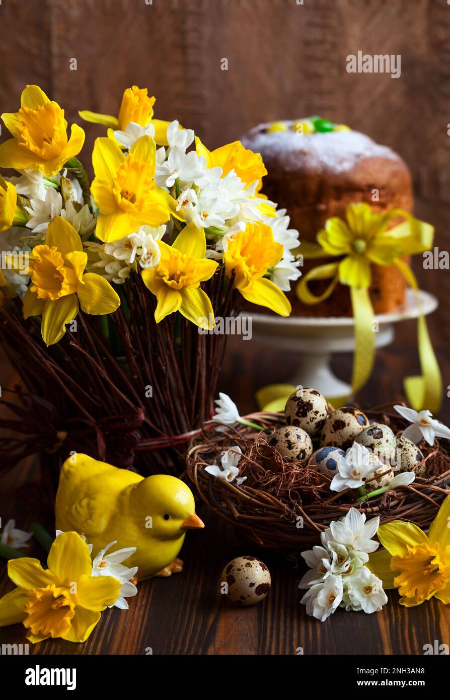 Easter table decoration with fresh daffodils,chick and eggs Stock Photo