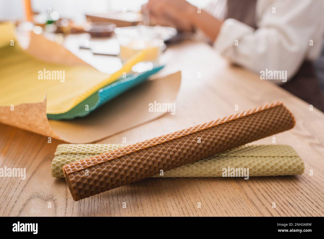 rolled wax sheets near cropped african american woman in craft workshop on blurred background,stock image Stock Photo
