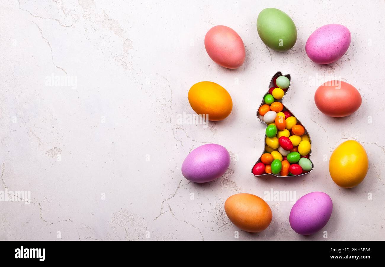 Easter concept with natural dyed easter eggs and candy. Flat lay Stock Photo