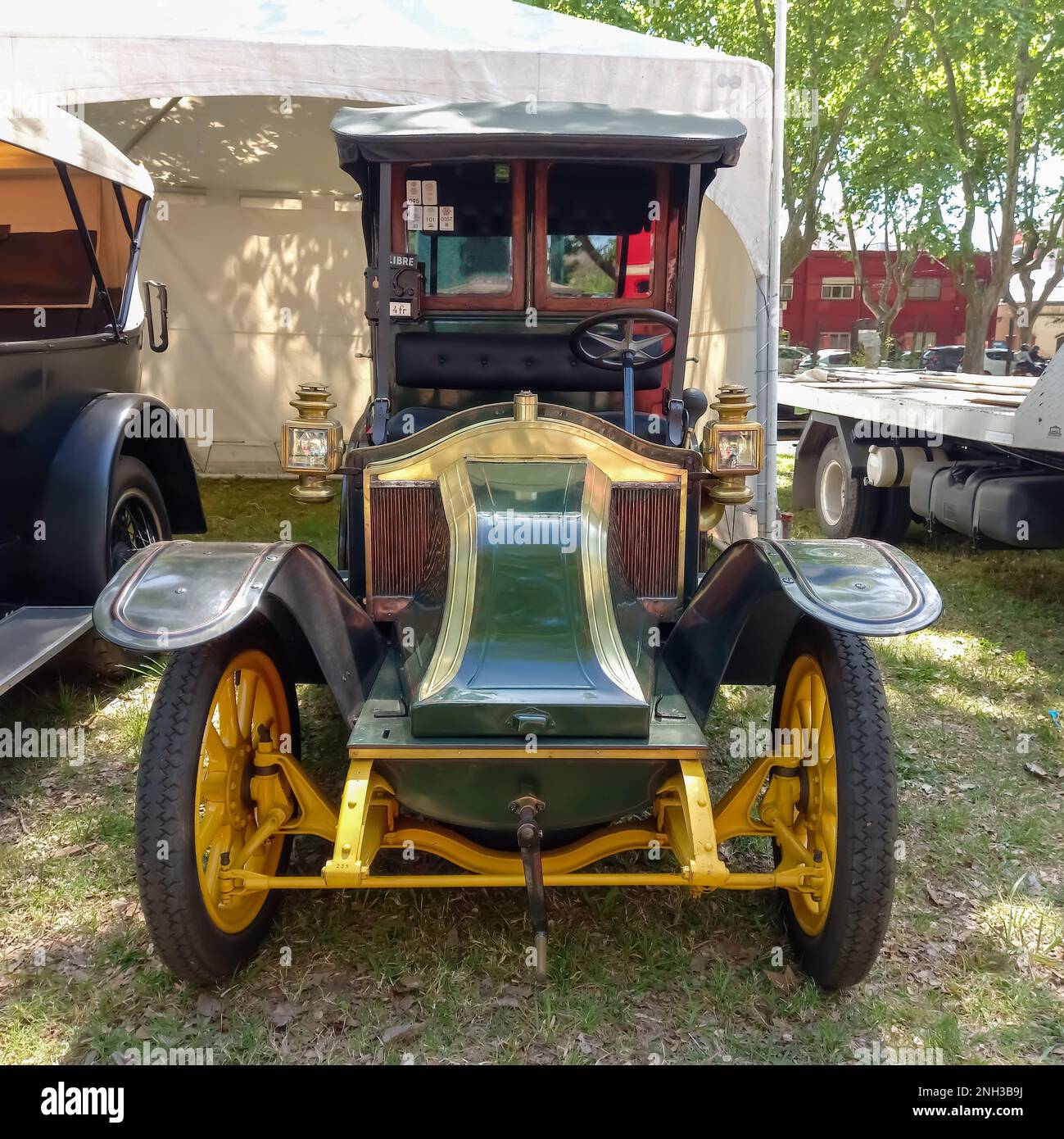 Old antique 1910s Renault Type AG cab Taxi de la Marne in a park. Nature, grass, trees. Autoclasica 2022 classic car show. Stock Photo