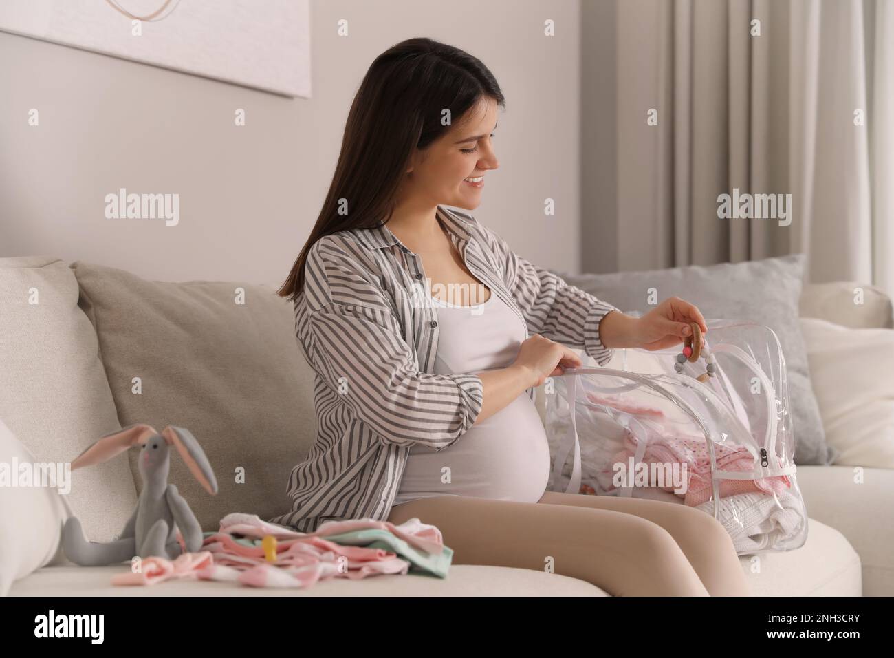 Pregnant woman packing bag for maternity hospital at home Stock Photo Alamy