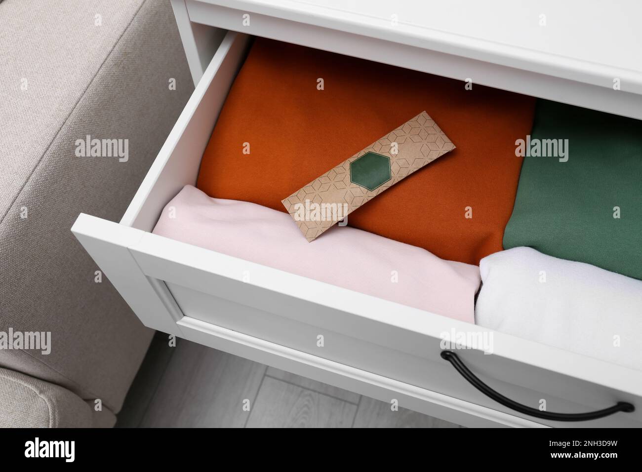 Scented sachet and folded clothes in drawer Stock Photo Alamy