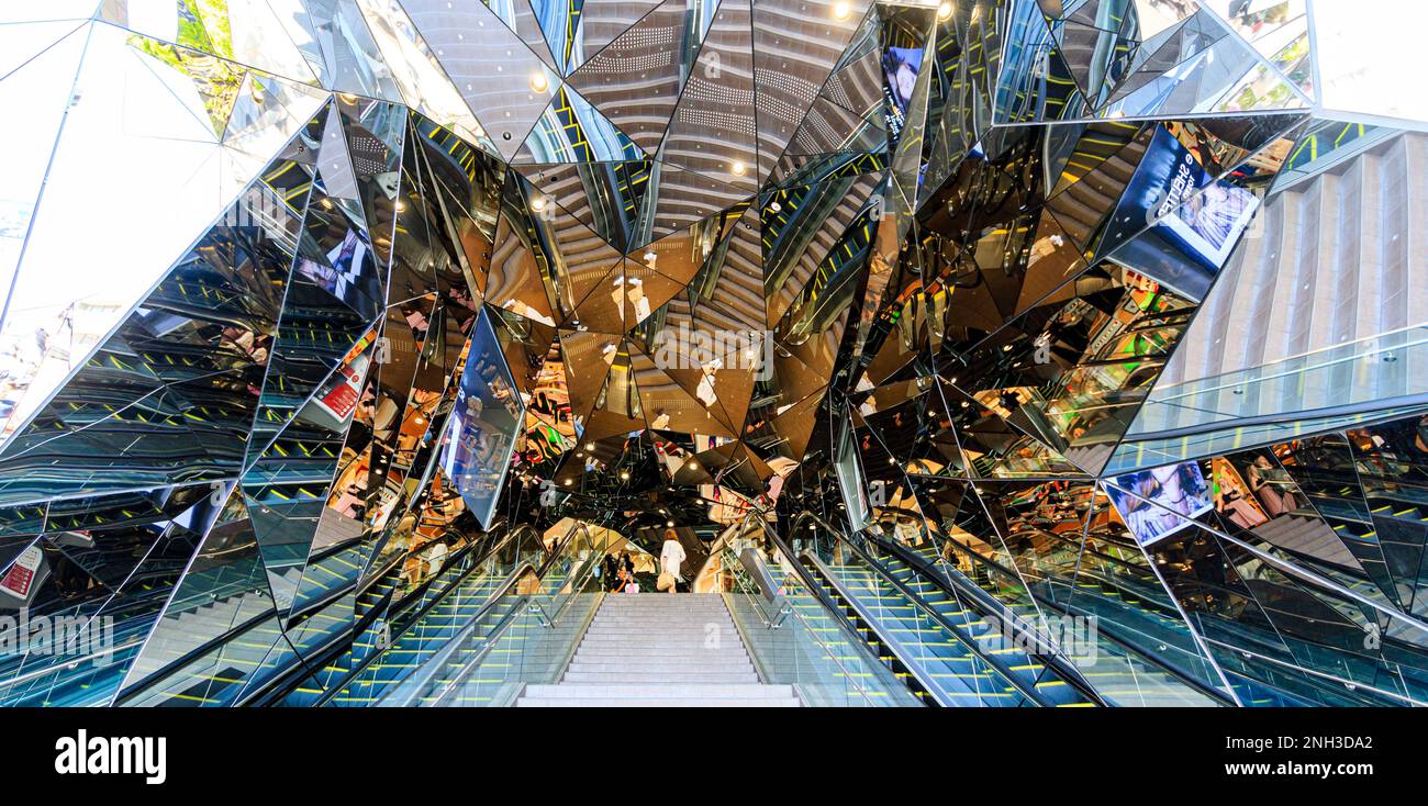 Hall of Mirrors entrance at the Tokyu Plaza building in Omotesando, Tokyo. View up the stairs and escalators into the maze of mirrors. Daytime. Stock Photo