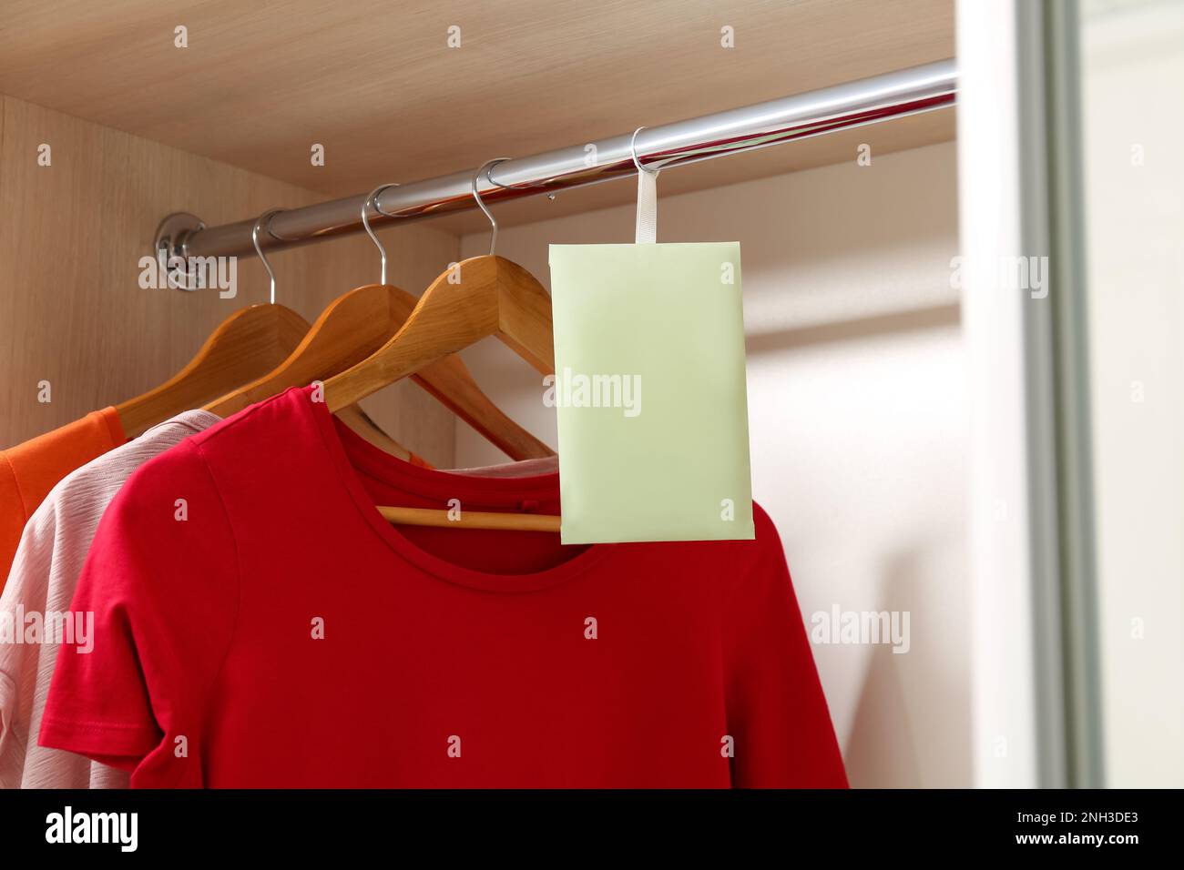 Scented sachet and clothes hanging in wardrobe Stock Photo Alamy