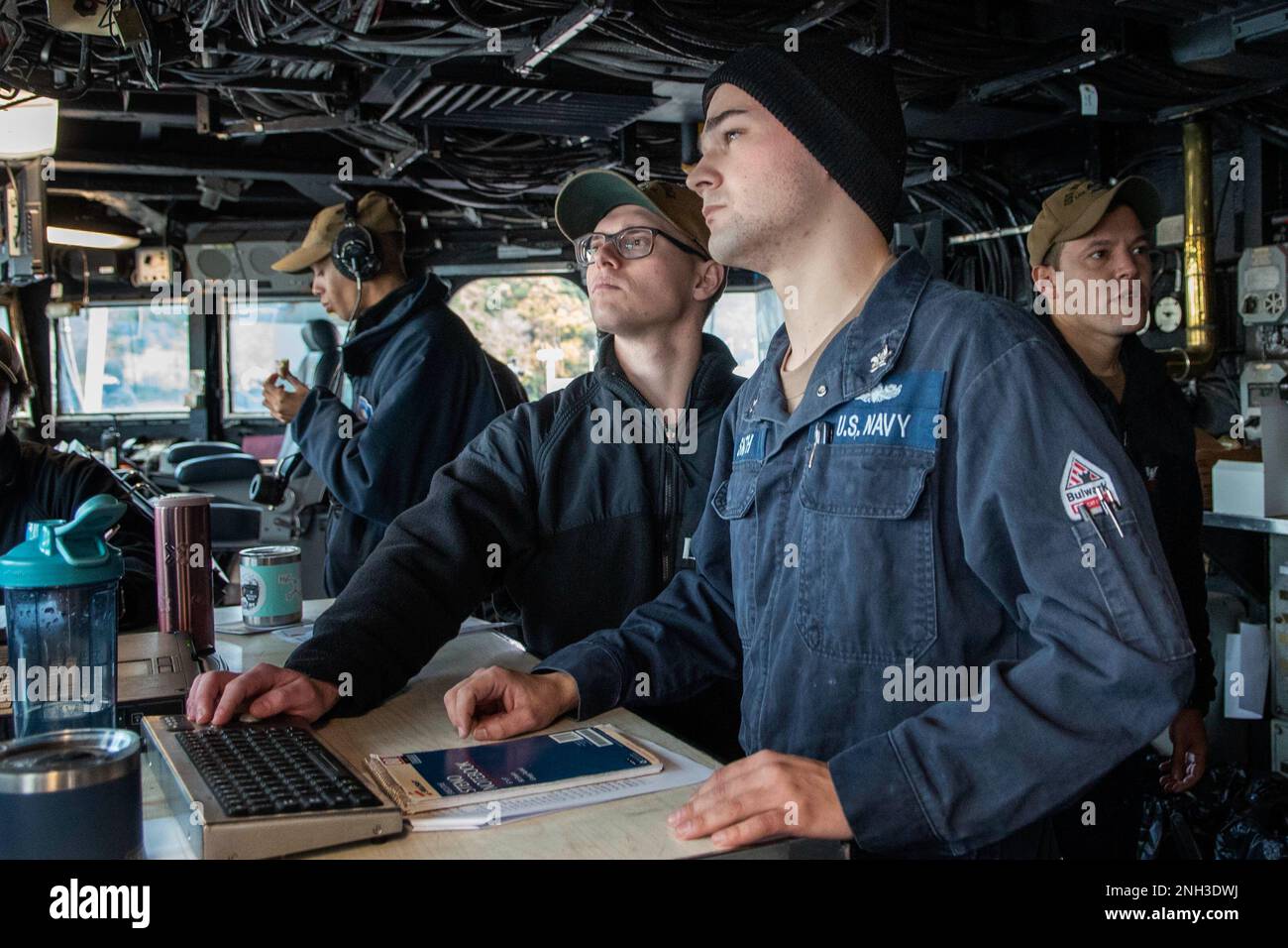 YOKOSUKA, Japan (Dec. 9, 2022) – Lt. j.g. Arthur Busick (Left), from Daniel Island, N.C., and Electronics Technician 2nd Class Zachary Smith, from Meridian, Idaho, look at a navigation system during a restricted maneuvering evolution aboard U.S. 7th Fleet flagship USS Blue Ridge (LCC 19), Dec. 9, 2022. Blue Ridge is the oldest operational ship in the Navy and, as 7th Fleet command ship, actively works to foster relationships with allies and partners in the Indo-Pacific region. Stock Photo